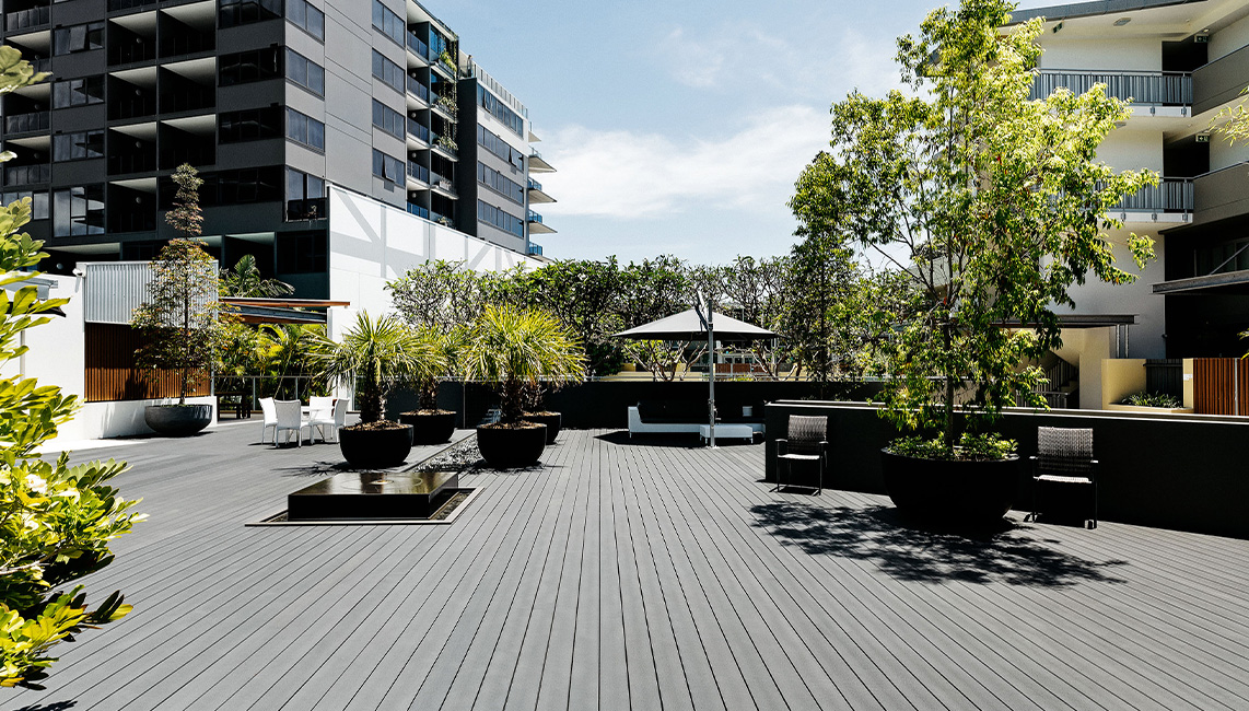 A composite decking with plants and trees.